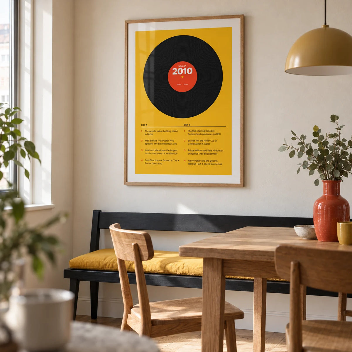 2010 Vinyl Record Print, framed on the wall of a modern dining nook in a British city flat with a cream wall and simple oak floor