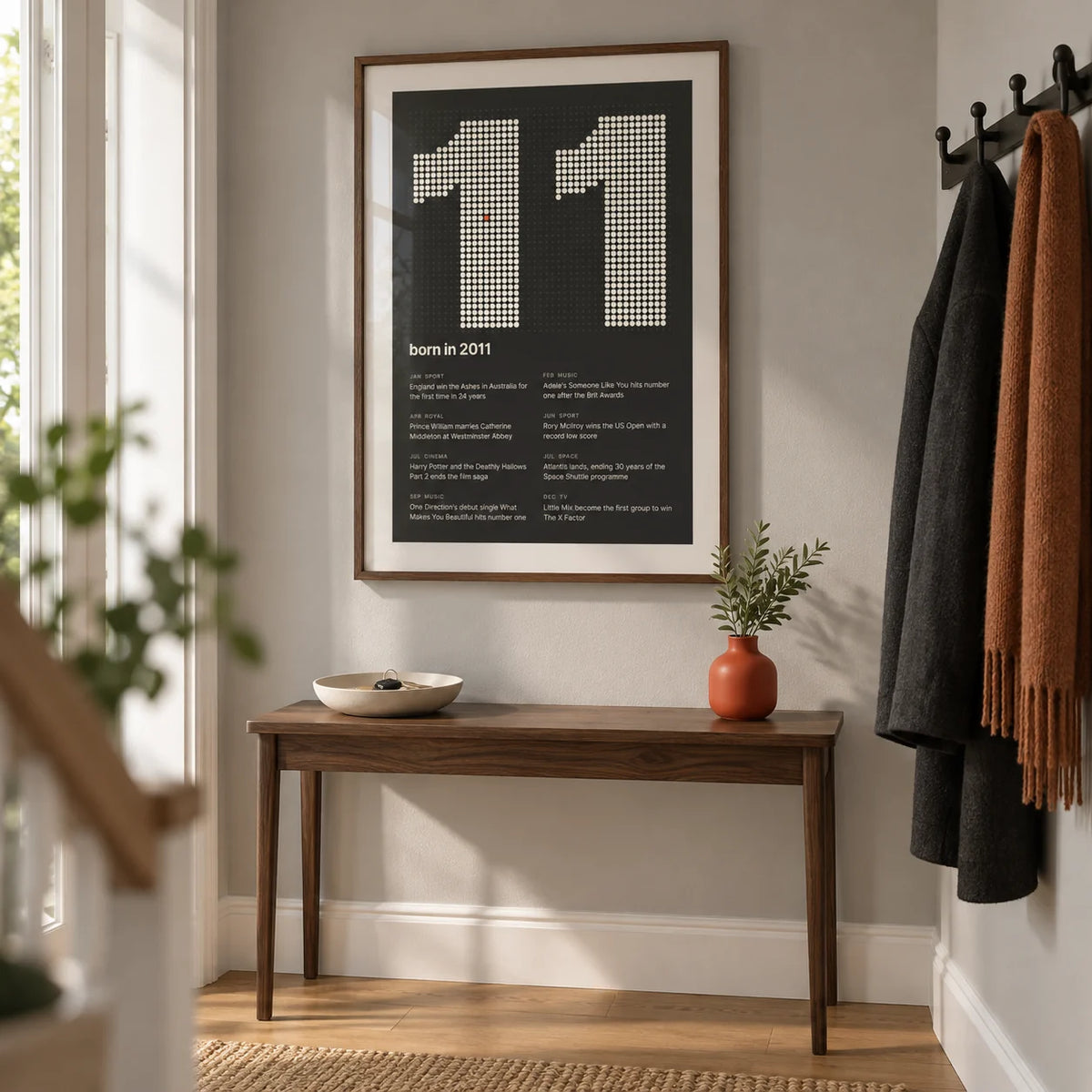 2011 Halftone Print, framed on the wall of a clean contemporary hallway in a British family home with a pale grey wall and oak floorboards
