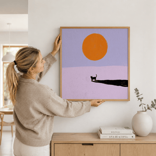 Framed mockup of cat silhouette poster with round sun motif and broad empty background in a minimalist style