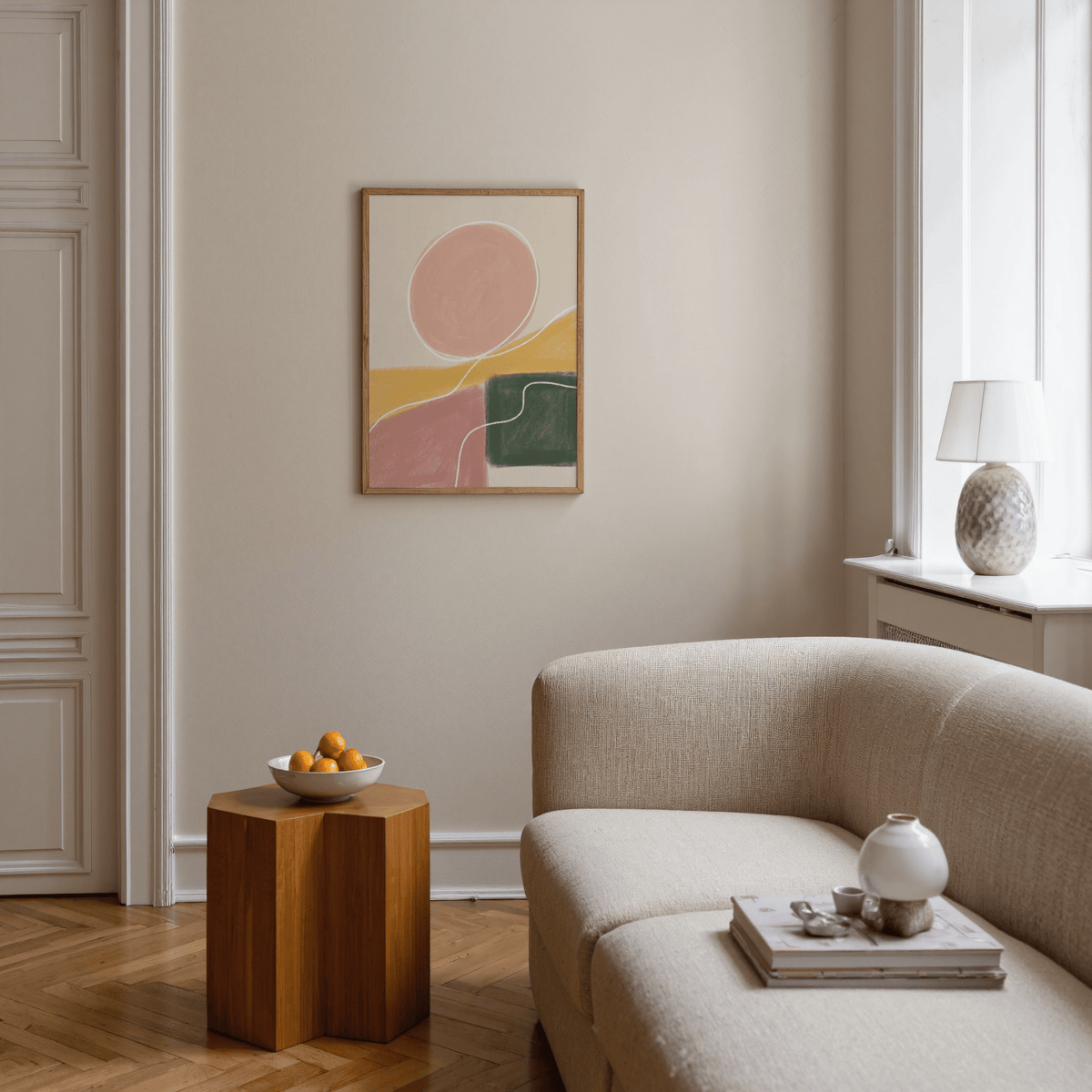 Modern living room with a beige sofa, wooden side table, and abstract art on the wall.