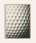 Close-up golf ball dimple pattern wall art print with grainy shading