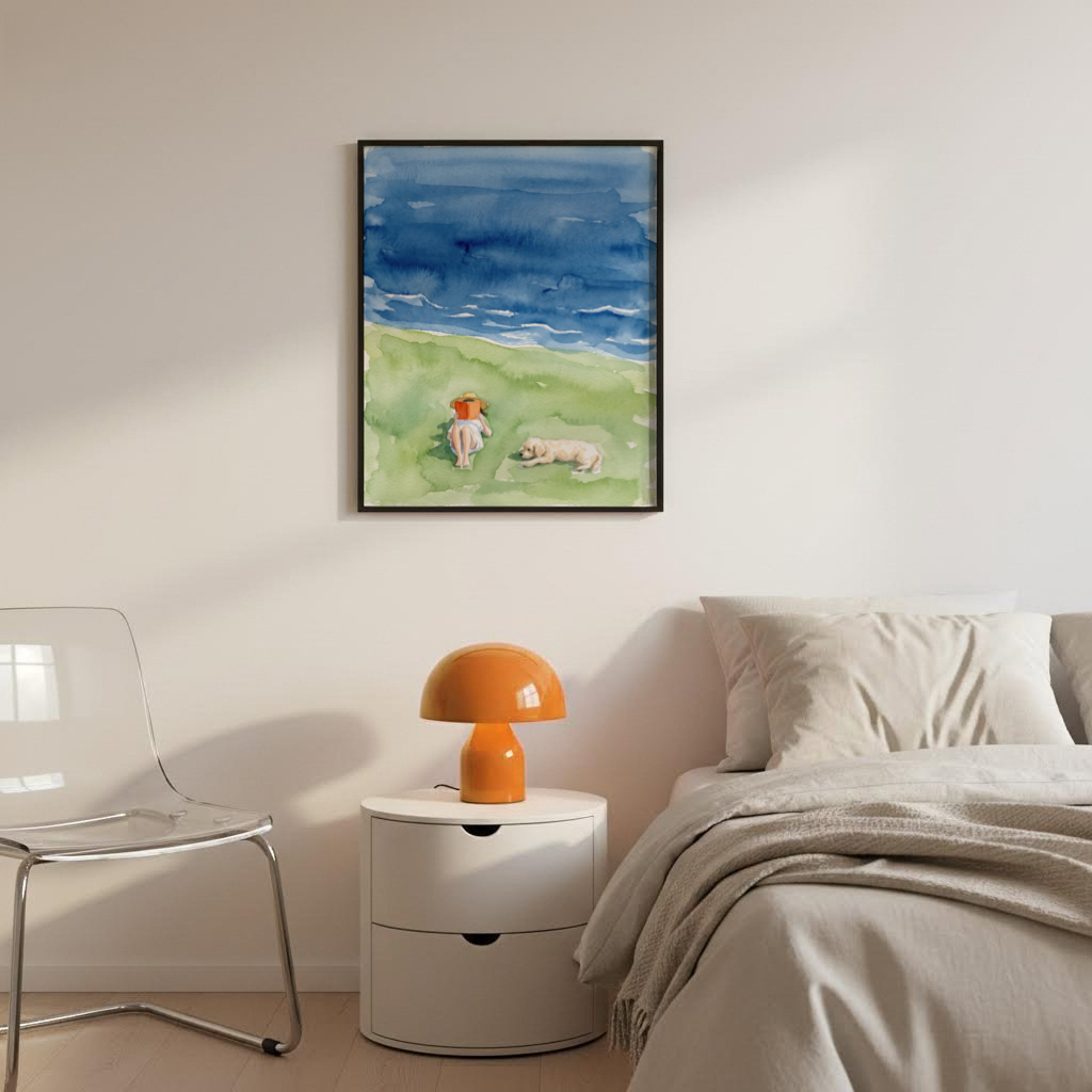 Minimalist watercolor wall art of a seaside reader on a grassy bank with open water in the background