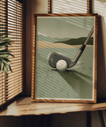 Vintage-style print of a golf iron and ball on grass with motion lines near the club