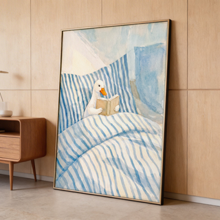Close-up Duck Reading Art Print print featuring a duck with orange beak reading in bed with blue and white stripes