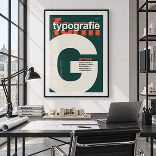Cream letter G on forest green print above a desk in a home office