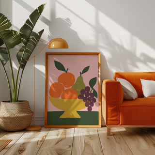 Mustard bowl of fruit on pink beside an orange sofa in a sunny living room