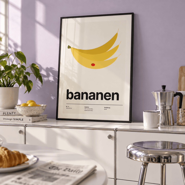 Yellow bananas with red sticker print in a breakfast kitchen against a lavender wall
