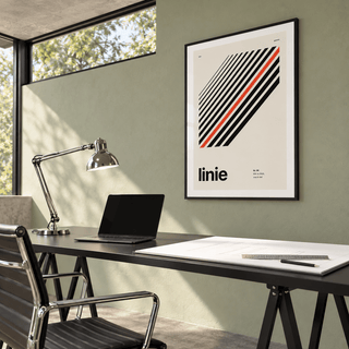 Parallel lines with one red line print above a desk in a home office