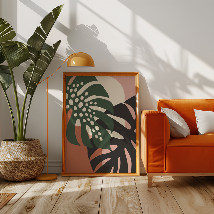 Dark green leaf with cream holes beside an orange sofa in a sunny living room
