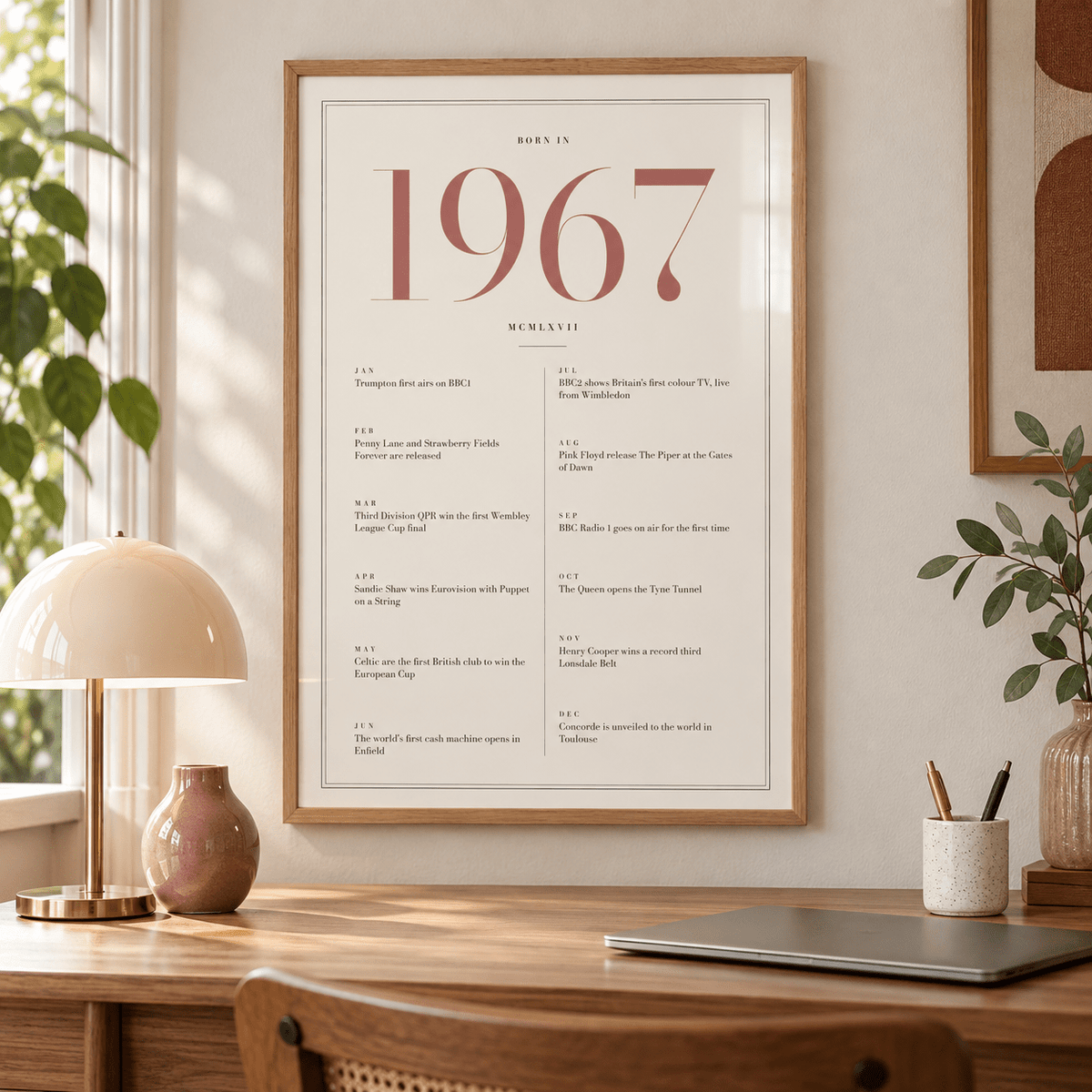 Cream and dusty rose 1967 birth year print on a wall in a lived in room
