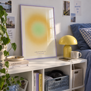 Mustard halo with green centre print on a shelf in a bedroom against a lilac wall