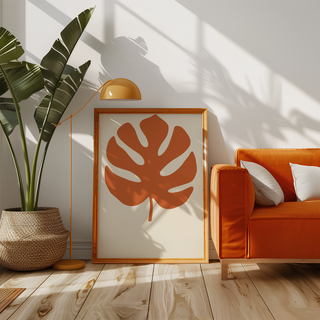 Single split leaf on warm cream beside an orange sofa in a sunny living room