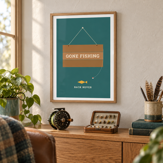 Wooden gone fishing sign on teal print above a desk in a quiet home study