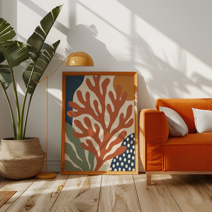 Rust red branching coral print beside an orange sofa in a sunny living room