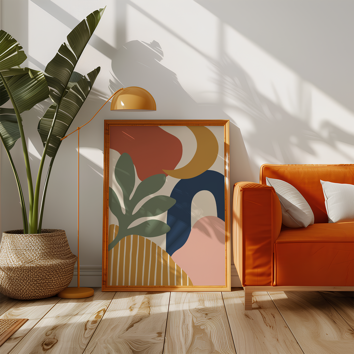 Cut paper print with a navy arch beside an orange sofa in a sunny living room