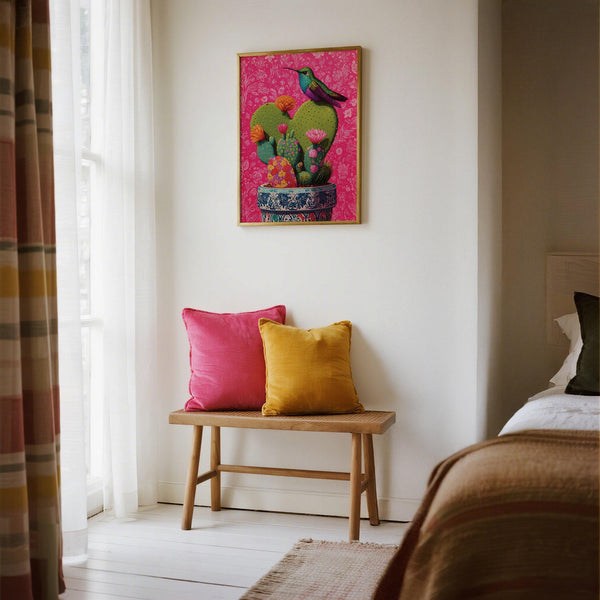 Colorful corazon de nopal cactus with blooming flowers and a bird perched on top.