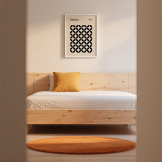 Contemporary mid century wall print with black circular pattern on cream-colored background.