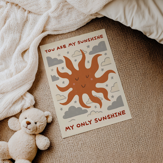 Graphic quote wall art print with sun face, repeating clouds, and small star motifs