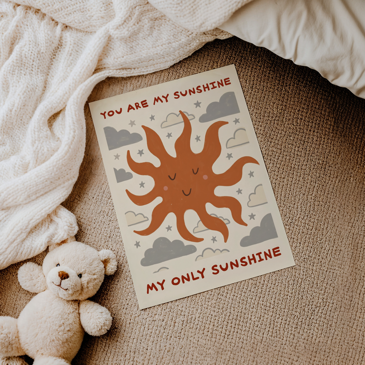 Graphic quote wall art print with sun face, repeating clouds, and small star motifs