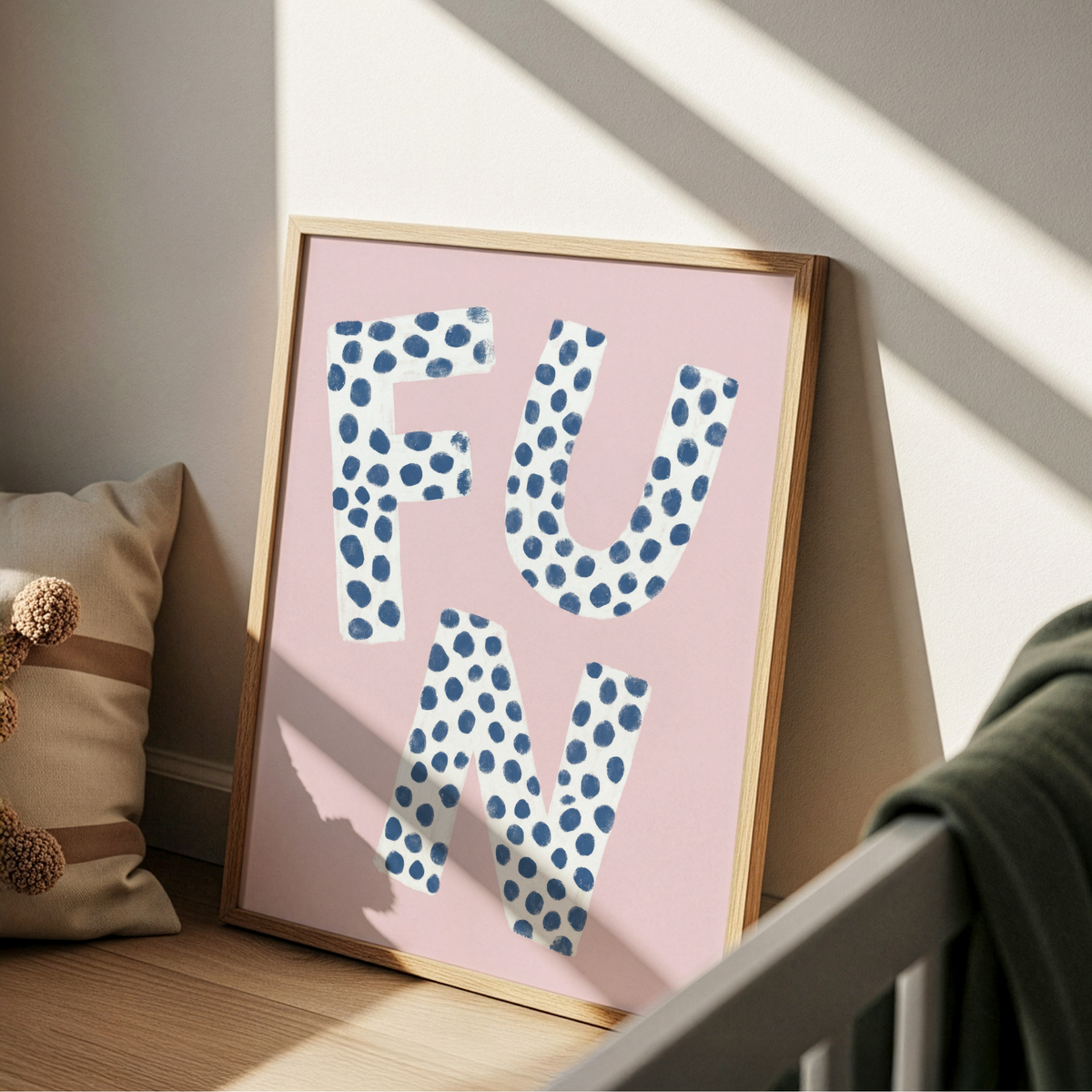 Playful typography wall art print showing the word FUN with blue polka dots