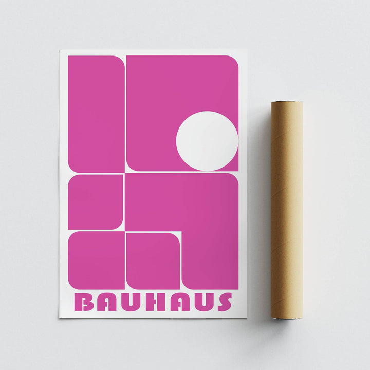 Pink wall art with geometric shapes and brown packaging tube on white background