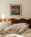 Overhead angle of Hasui Kawase sunset seascape print on wooden desk