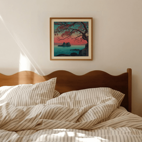 Overhead angle of Hasui Kawase sunset seascape print on wooden desk