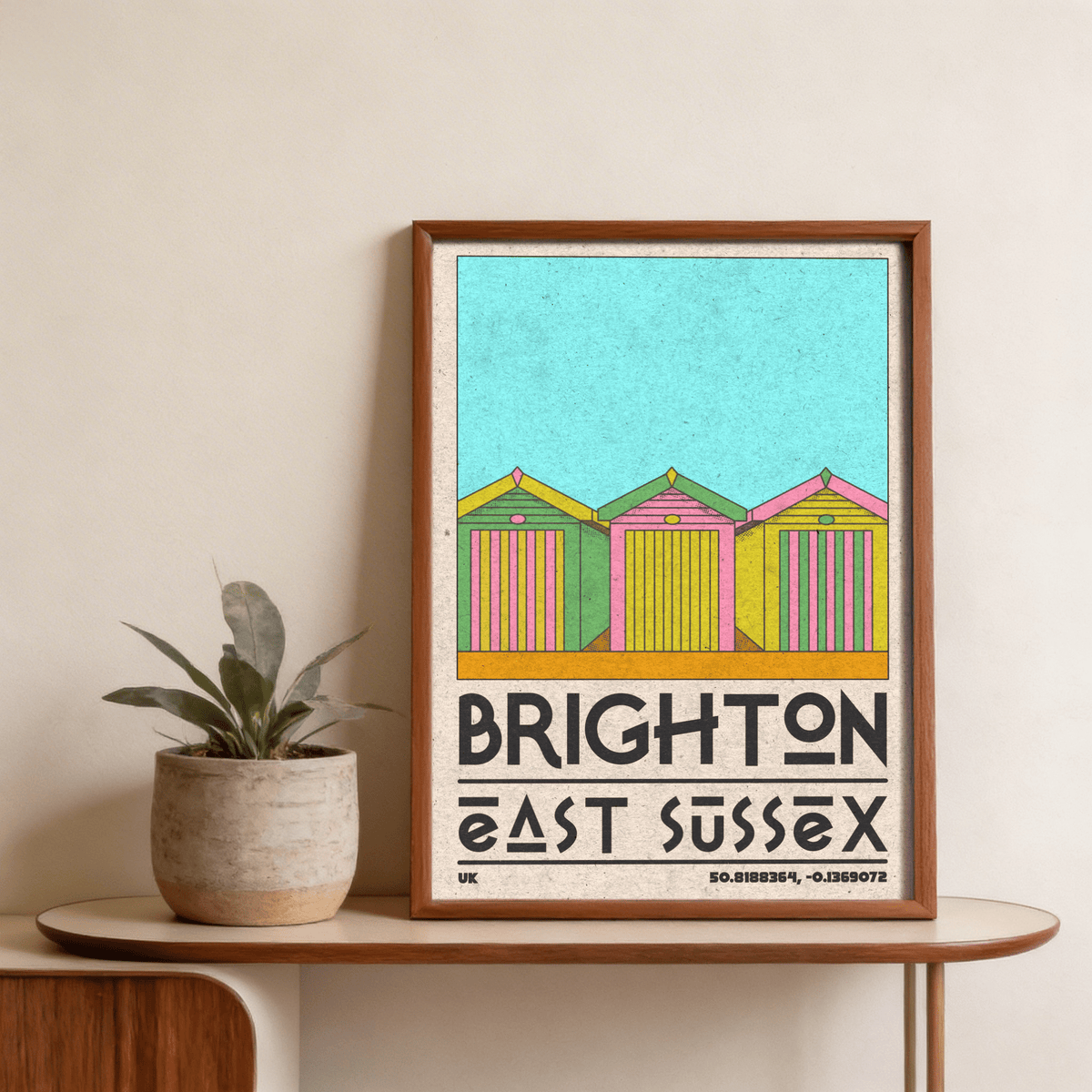 Seaside huts illustration with bold BRIGHTON lettering and coordinates