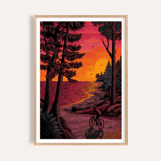 Framed Bicycle Adventure Print of a cyclist at sunset with pink and orange sky