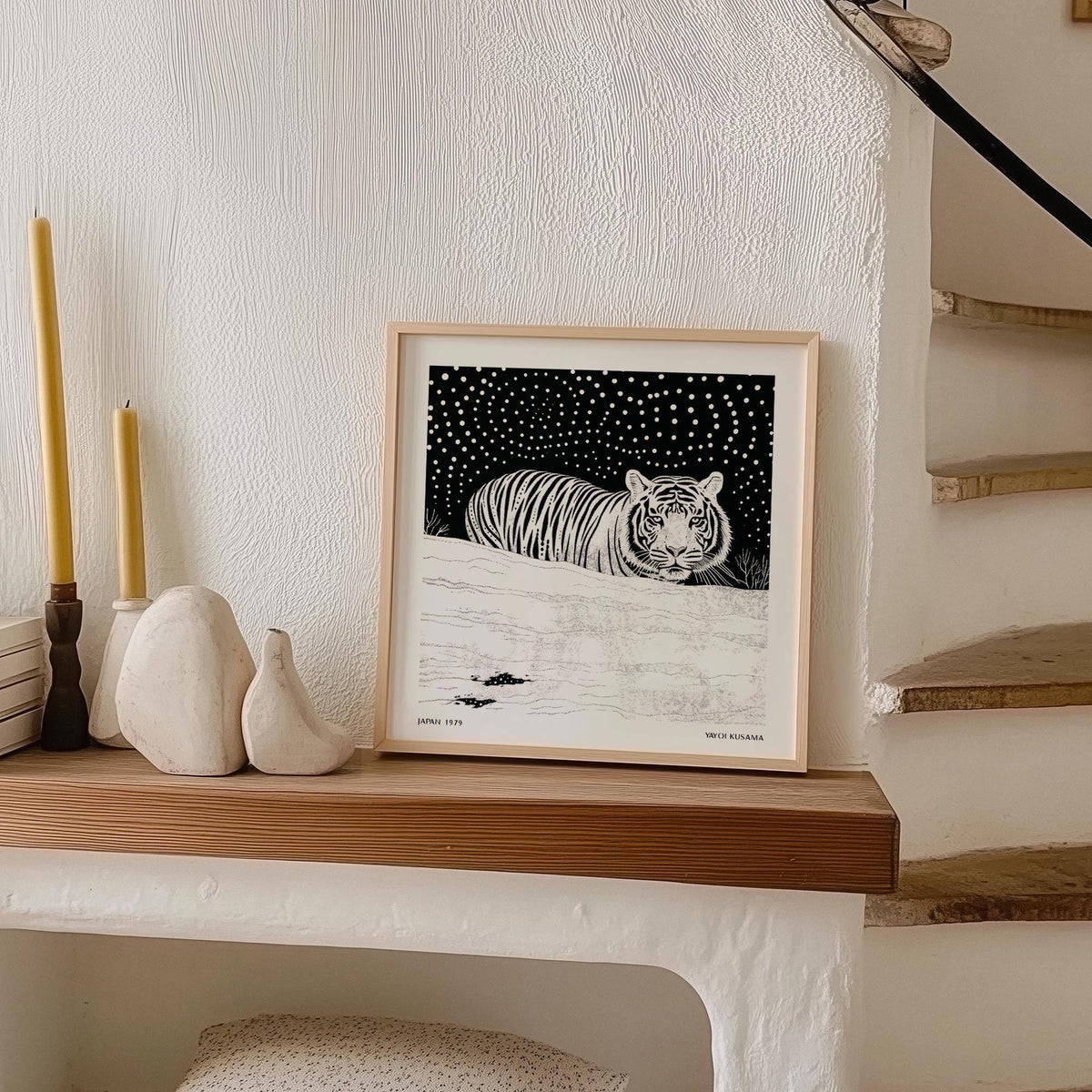 Black and white snowy scene featuring art white tiger in motion