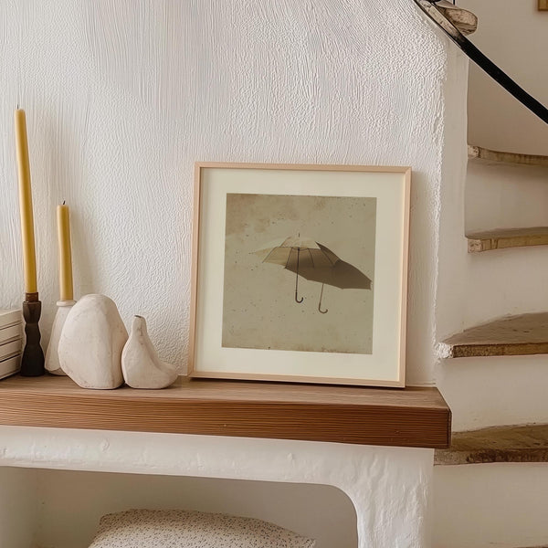 Optical illusion wall art featuring an umbrella with two handles