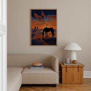 Grazing horse silhouette poster set against sweeping sunset sky lines