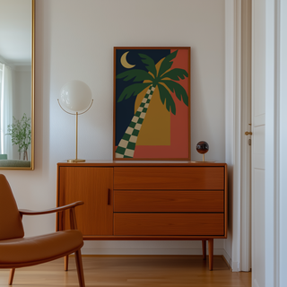 Cut paper palm under a crescent moon above a mid century sideboard in a hallway