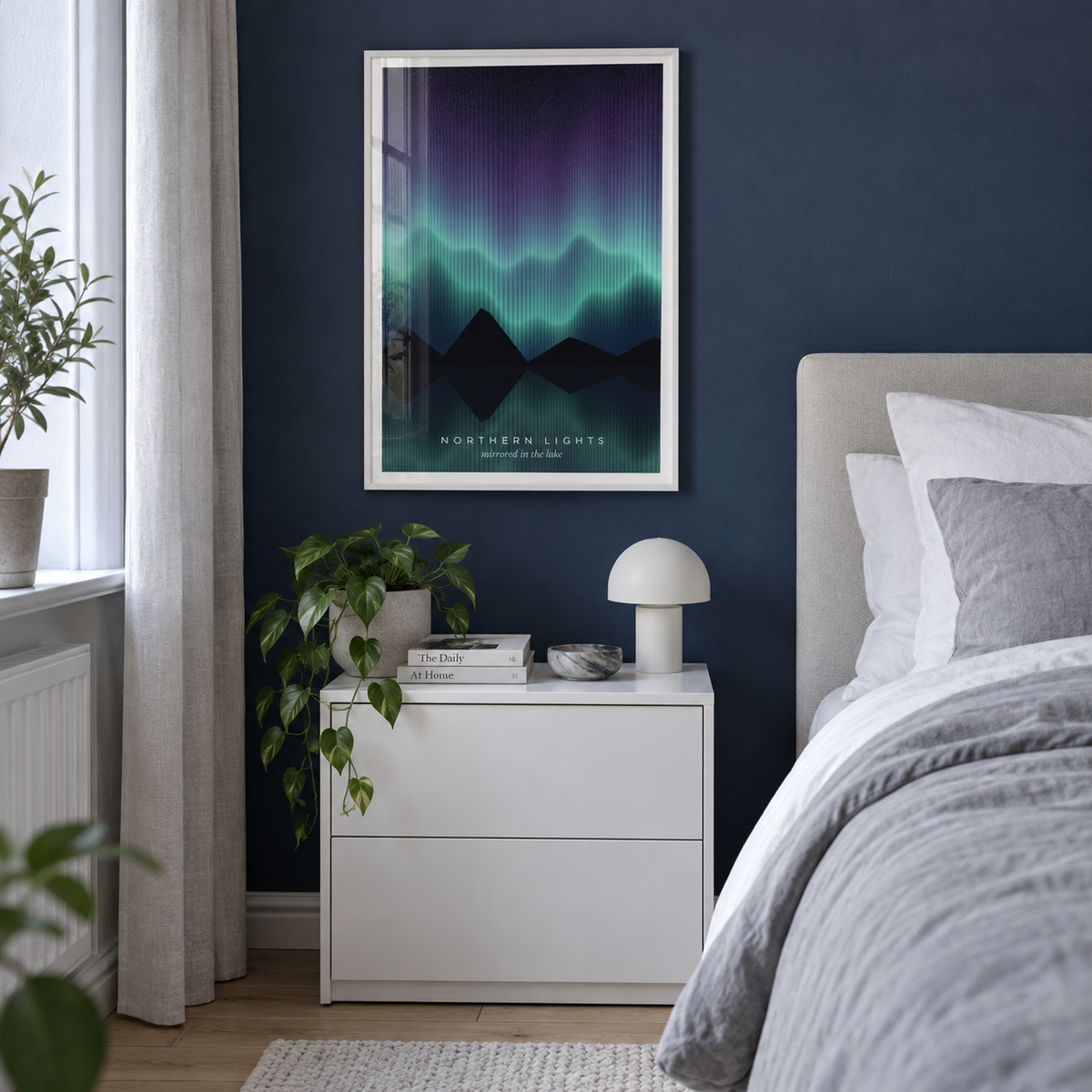 Teal aurora over mountains and water print on a shelf against a sage wall