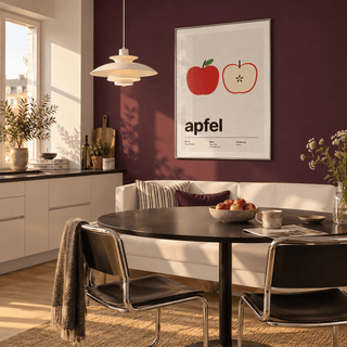Swiss style apple typography print in a dining room against a plum wall