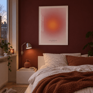 Orange sun gradient print on pink in a bedroom against a burgundy wall