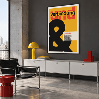 Swiss style ampersand typography print above a sofa in a living room