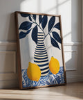 Lemon art print featuring two yellow lemons and navy blue leaves in a striped vase.