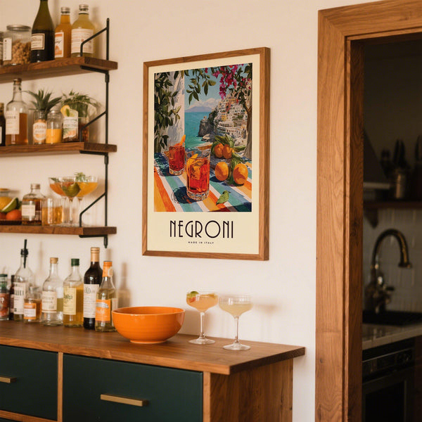 Orange trees and Negronis in Italian Drink Posters set on striped patio table.