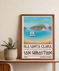 Seaside travel wall art print featuring a curved beach foreground, sailboats, and a distant island with small building