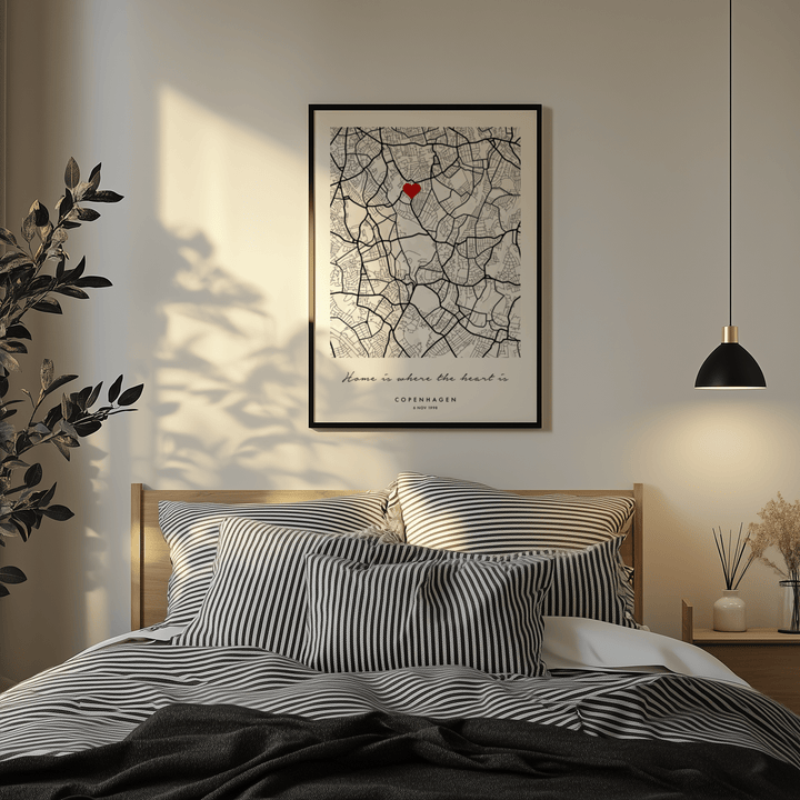 Custom Anniversary Gift of minimalist city map with red heart above a bed with striped pillows