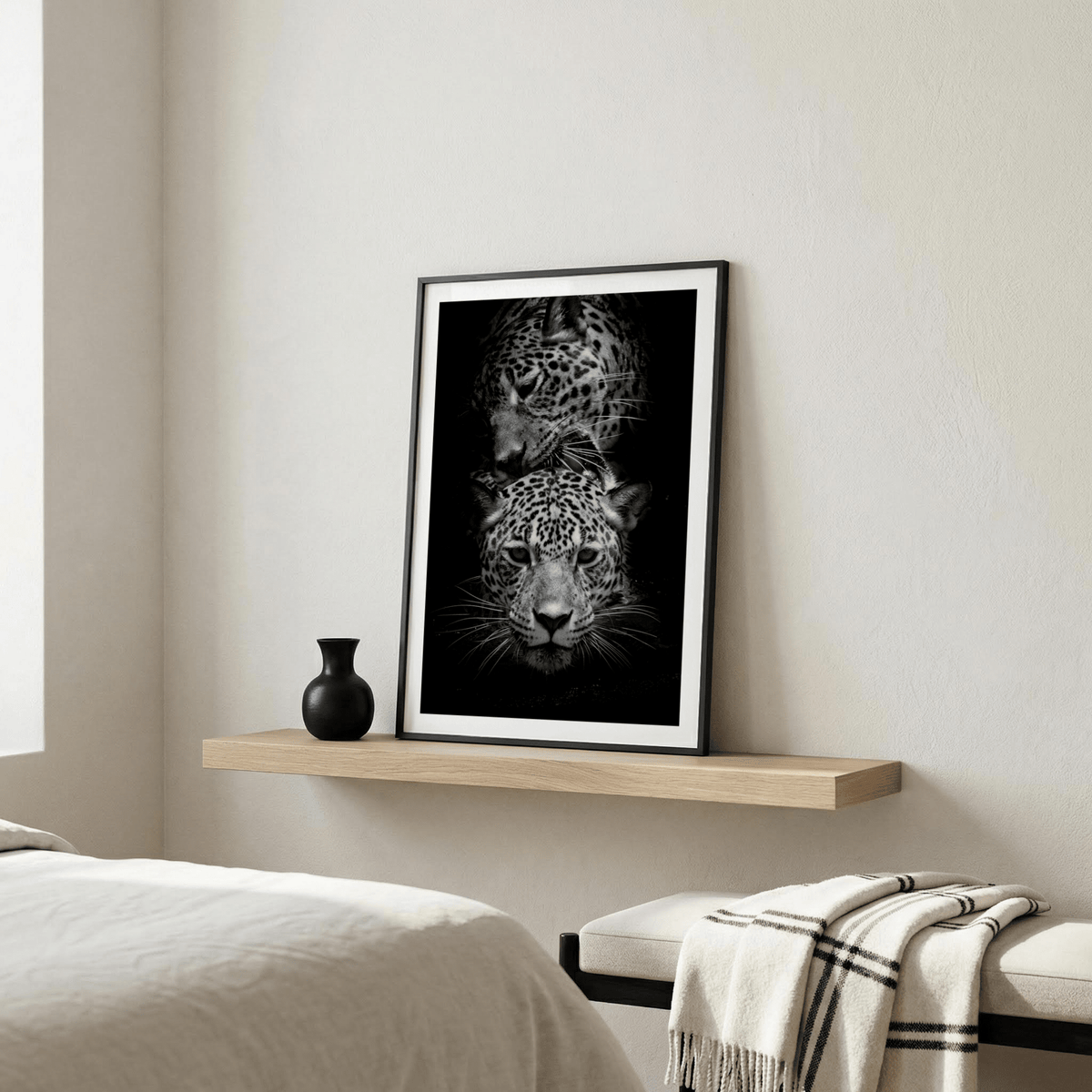 Black and white leopard wall art focusing on eyes, whiskers, and spots