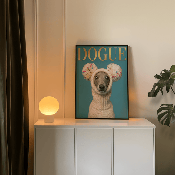 Print on a wall of Fashion Dog Poster showing a grey dog in a cream knit hat with colourful pom poms next to a lamp