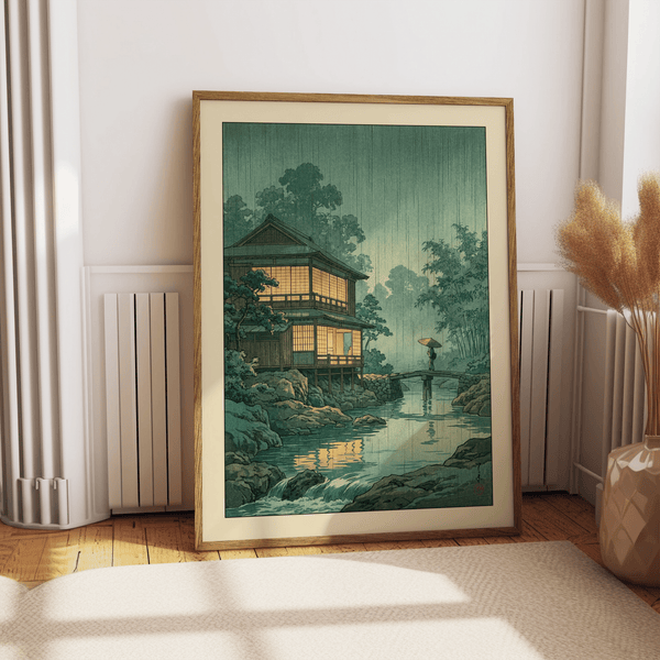 Traditional-style print of a riverside house, arched bridge, and umbrella figure wall art