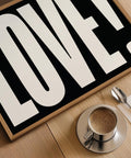 Contemporary LOVE wall art in monochrome for entryway styling.