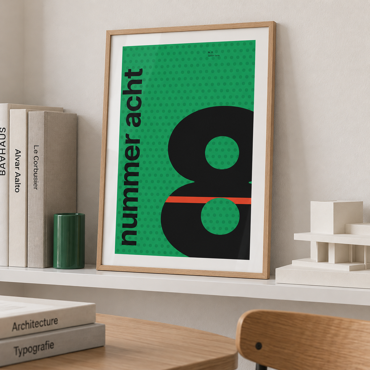 Giant black number 8 on green print leaning on a picture ledge