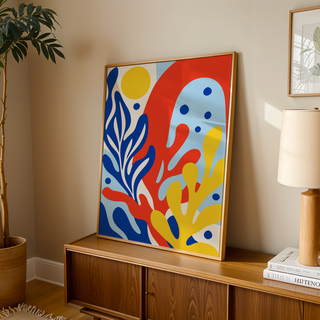 Primary colours print of coral shapes leaning on a wooden sideboard in a warm living room
