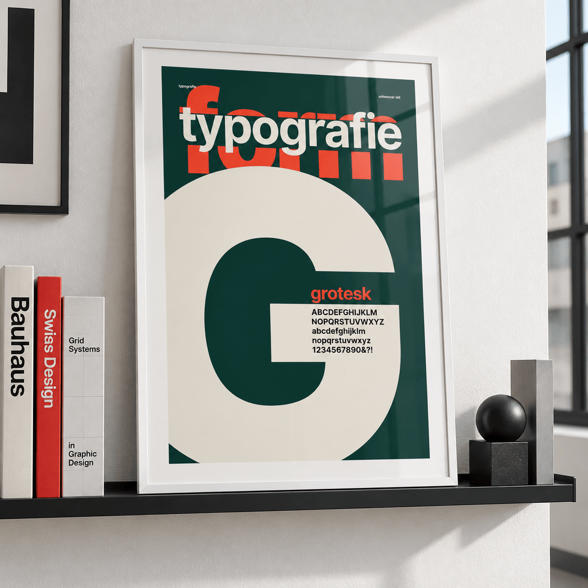Giant letter G typography print leaning on a picture ledge