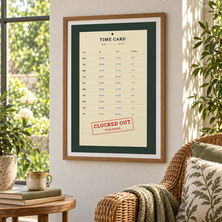 Clocked out time card print in a garden room filled with green plants