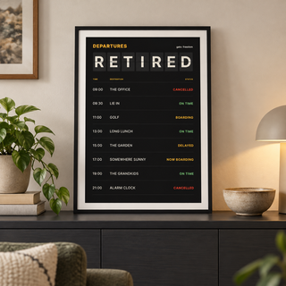 Departures board retirement print above a sofa in a relaxed living room